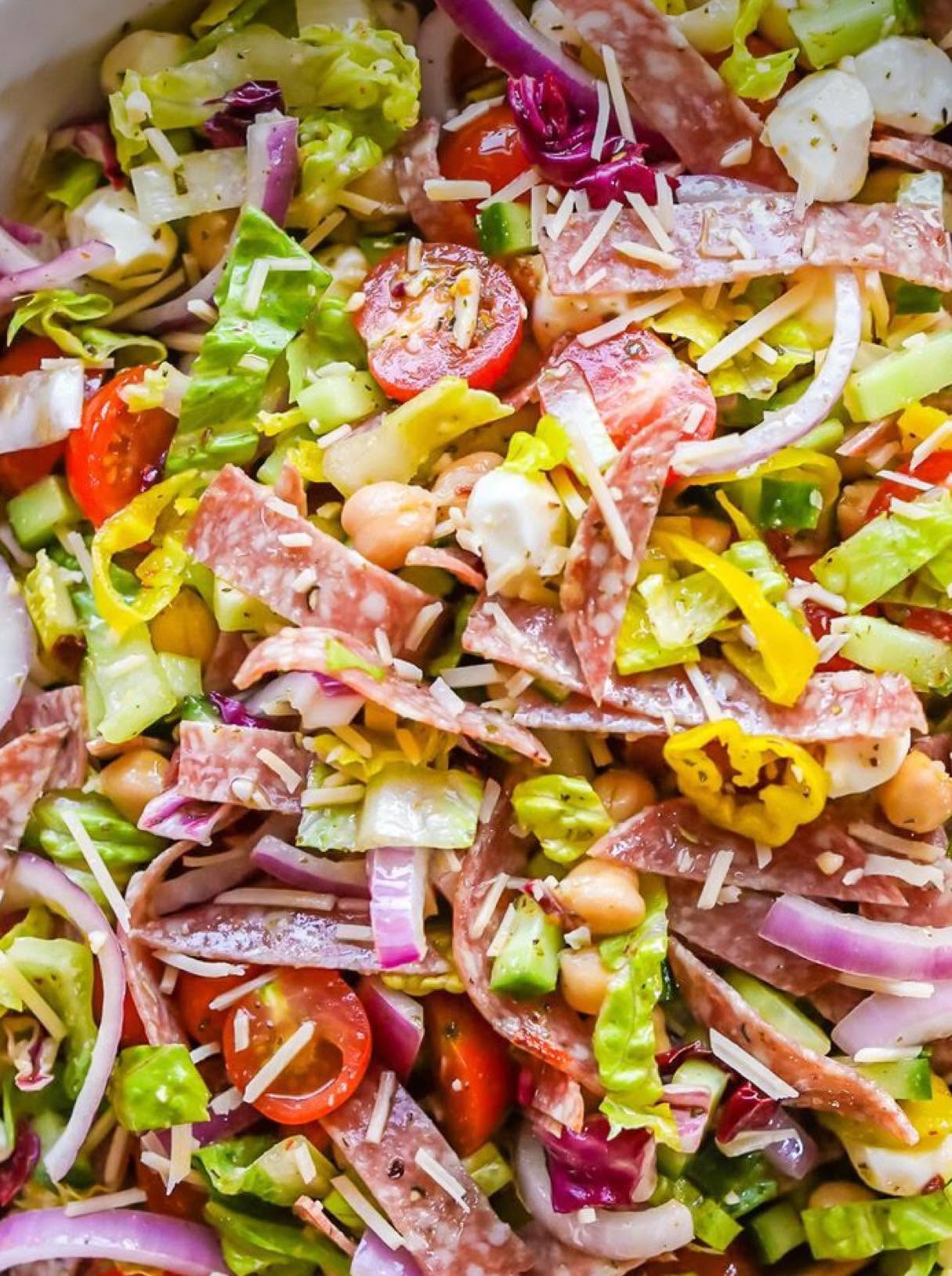 Italian chopped salad with salami and fresh vegetables