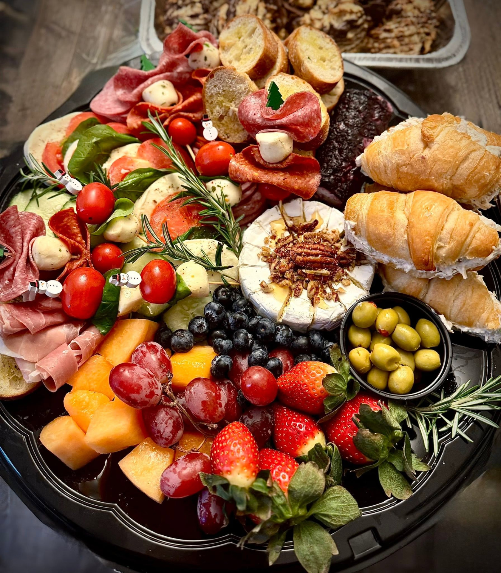 Abruzzo's catering tray with Italian meats, cheeses, fruit and sandwiches
