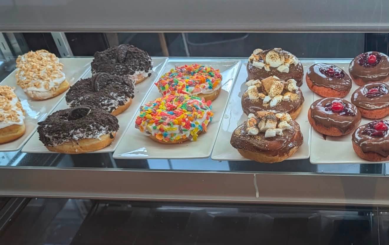 Colorful freshly made doughnuts in the bakery case