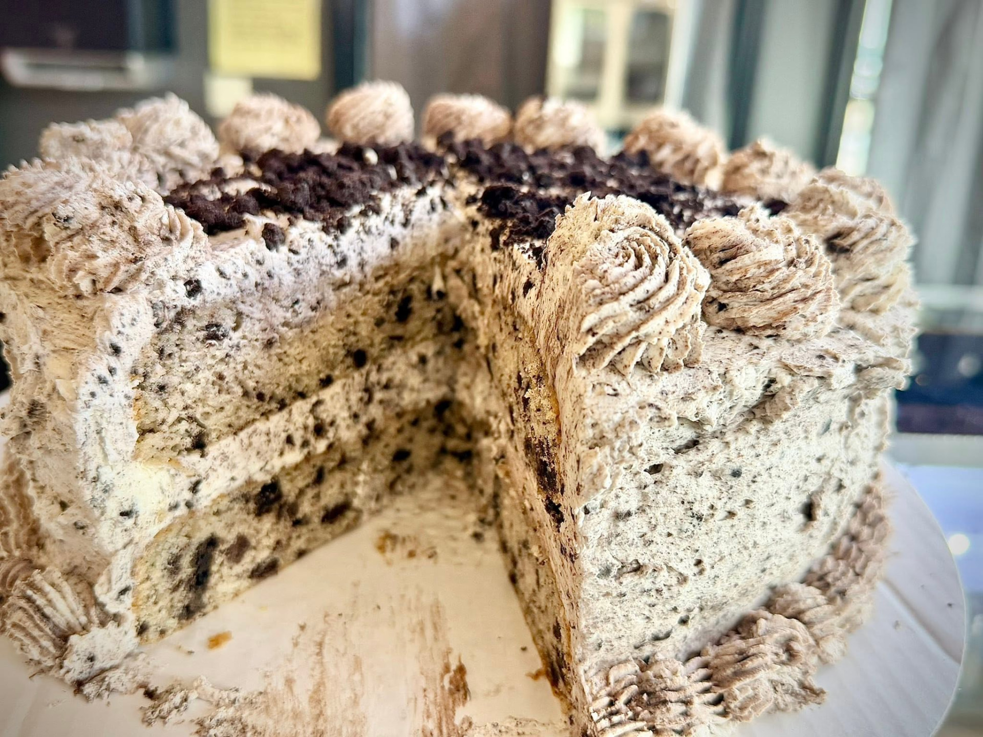 Oreo cheesecake with piped cream and cookie crumbs