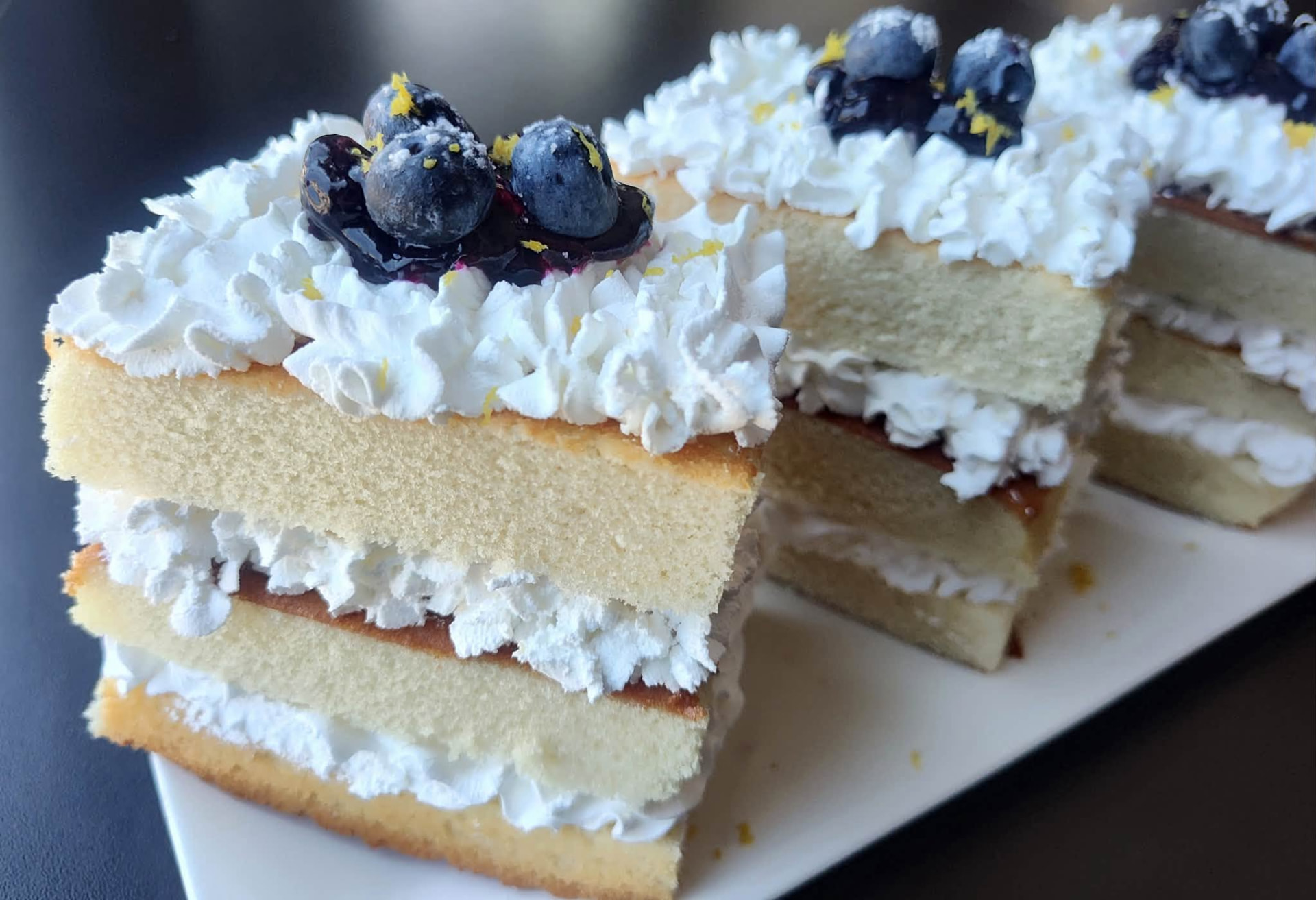 Vanilla layer cake slices topped with blueberries