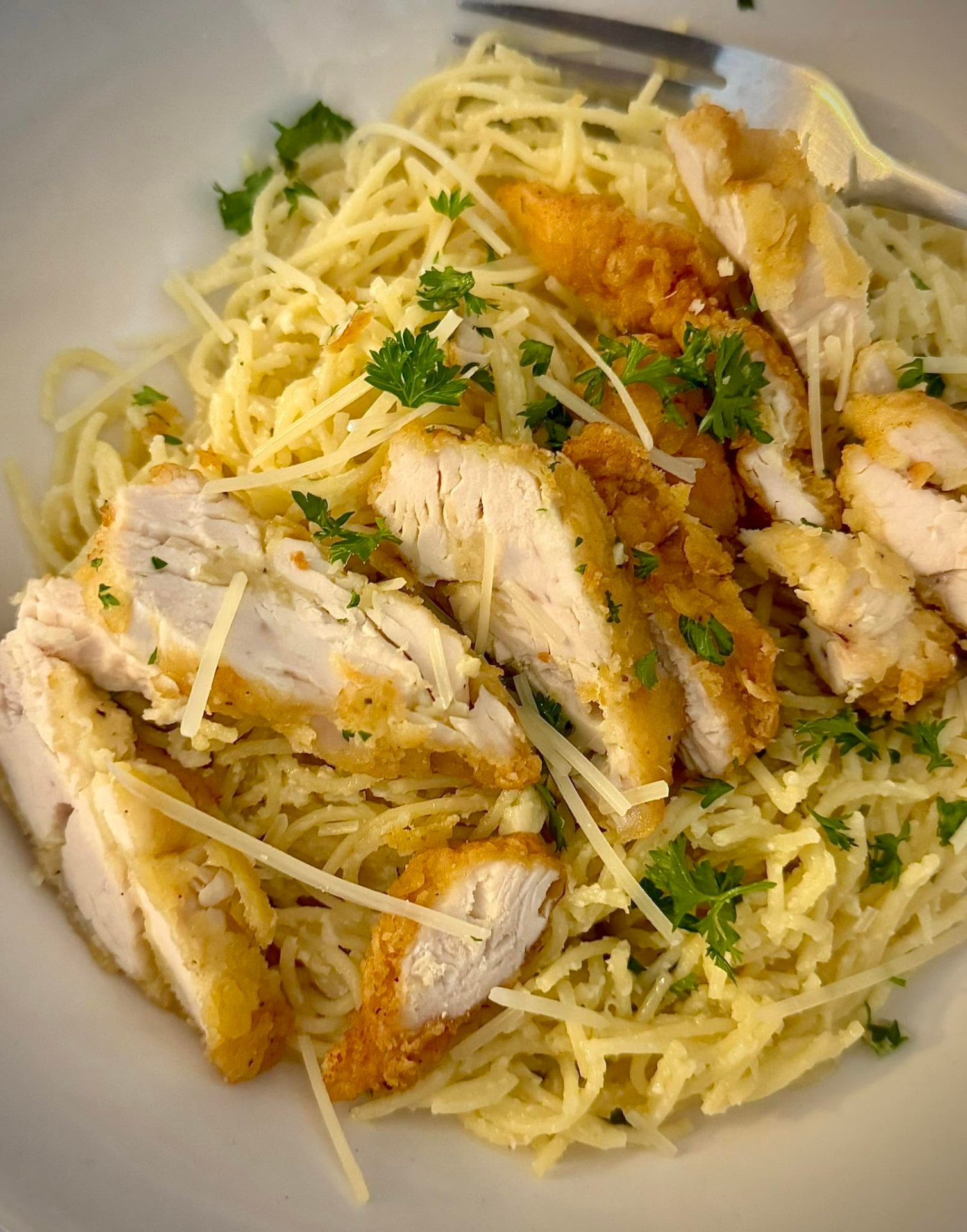 Chicken pasta finished with parmesan and parsley