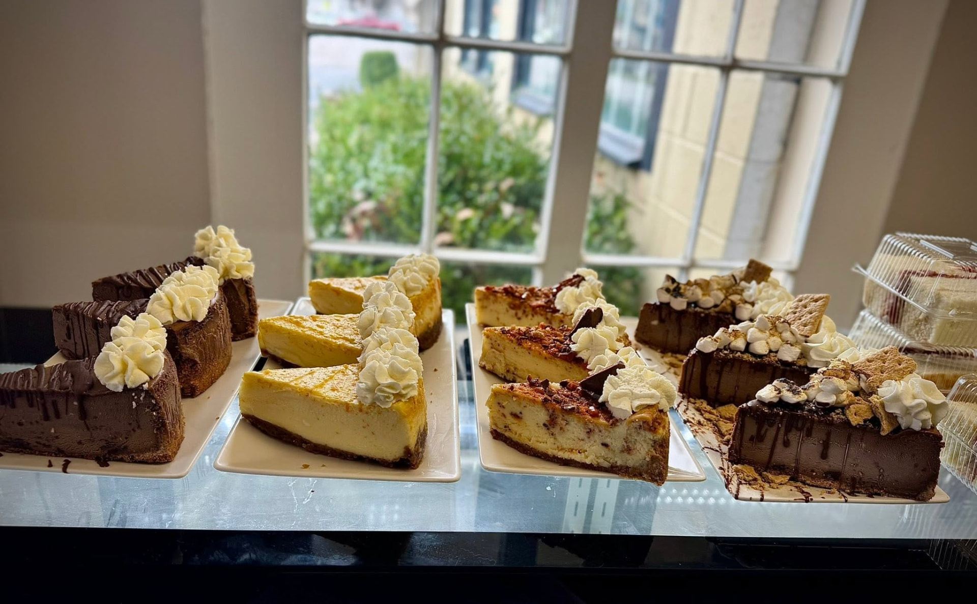 Assorted cheesecake slices in the bakery case